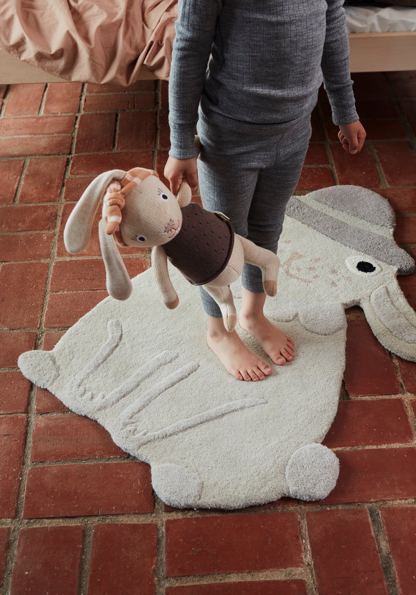 Tapis enfant en forme de lapin gris clair à relief 3D, texture douce et peluche.