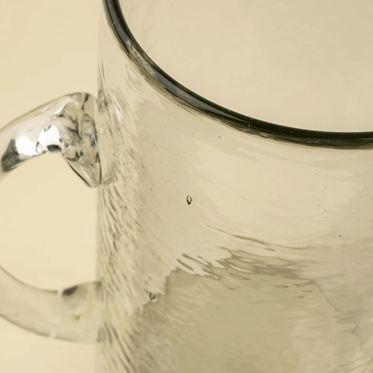 Pichet en verre soufflé, bec verseur et texture martelée visible en relief