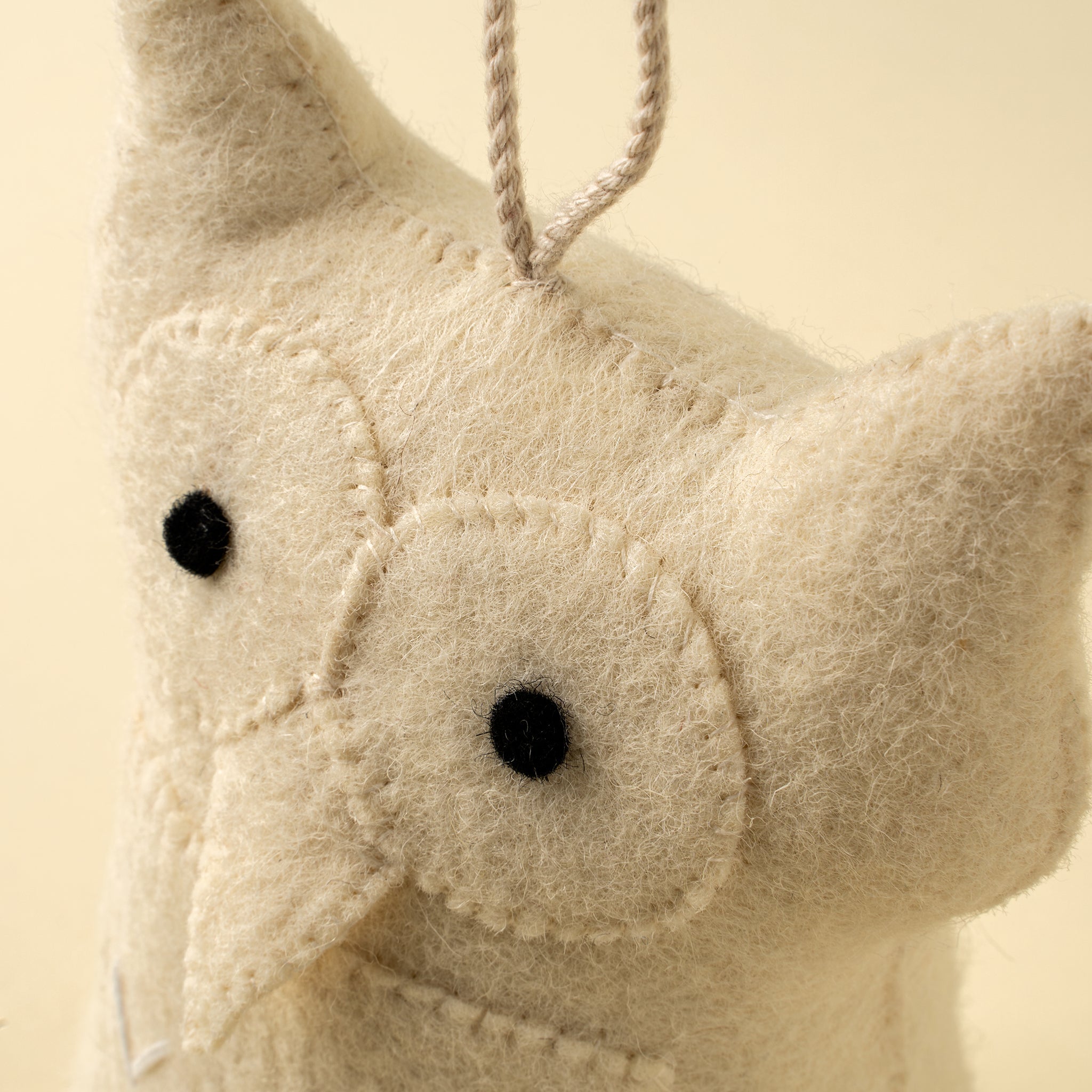 Butée de porte en feutre hibou beige avec yeux noirs et cordelette